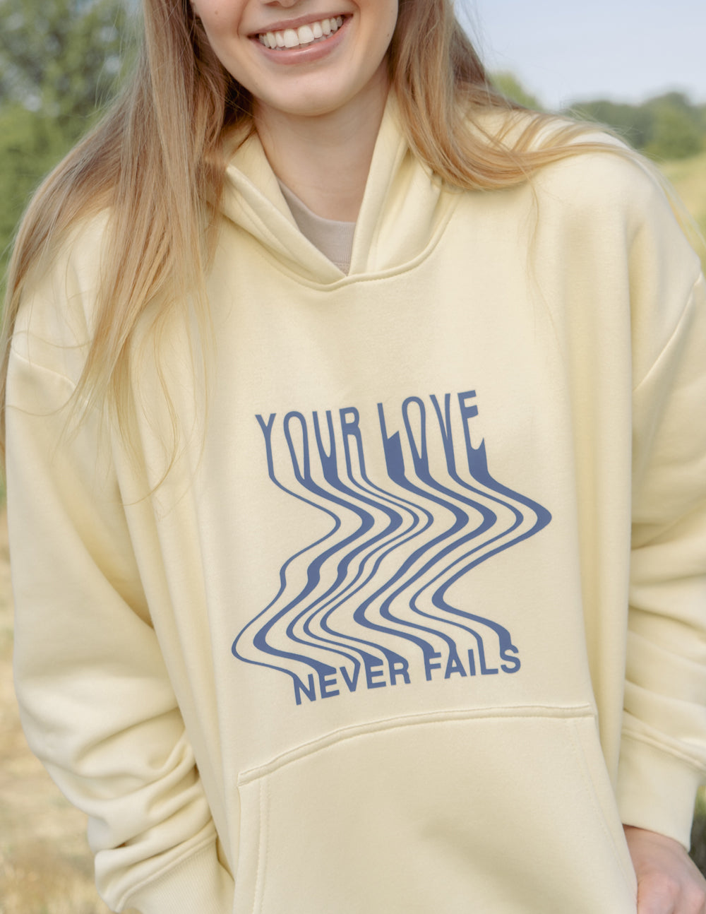 Elevated Faith Love Never Fails Cream Unisex Hoodie - AVBL MRKT (7)